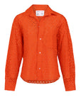 The Daily Shirt by Cissa is a bright orange long-sleeve crop shirt in airy paper cotton eyelet lace, with a collar, chest pocket, and all-over cut-out floral pattern—perfect for standing out every day.