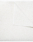 White textured Coverlet King with a waffle pattern, neatly folded with slight creases visible, showcasing a fluffy and soft appearance in a Scottsdale, Arizona bungalow by John Robshaw.