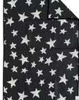 The Faire Double Sided Hand Towel is a black, rectangular waffle weave microfiber towel with white, irregular star patterns on both sides. One corner is folded to show the reverse's matching design.