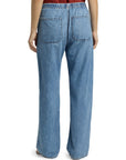 Someone stands with their back to the camera, wearing Rag & Bone ftwt logan pull on track jeans—relaxed straight fit in blue cotton-blend denim with an elastic waistband and two back pockets.