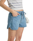 Wearing the Rag & Bone uftwt nolan short with a drawstring waist, paired with a blue and white sleeveless top and holding a woven clutch, this look captures effortless rag & bone style.