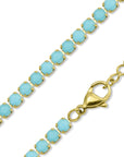 The Faire Turquoise Tennis Necklace features round turquoise rhinestones on 18K Gold PVD coated stainless steel with a lobster clasp closure, shown close-up against a white background.