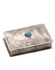 The J Alexander Rustic Silver 83-1-T Stamped Rec Box Turq is a handcrafted rectangular silver box with engraved patterns and an oval turquoise stone on the lid, ideal as a Southwestern-inspired decorative treasure box.