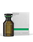 A brown glass bottle of The Nue Co Functional Fragrance 50ML, created to help de-stress, is placed beside its white and green box labeled "De-Stress" and "Eau de Parfum 50ml.