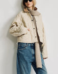 Denimist Faulkner quilted jacket with knit scarf, styled casually outdoors by a white wall.