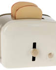 Maileg off-white toaster with two toasted bread slices, front view, by Bungalow Furniture & Accessories.