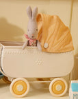Maileg Micro Pram in yellow with tiny bunny wearing a pink scarf, styled with milk carton. Bungalow Furniture & Accessories.