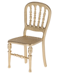 The Maileg Furniture gold-colored chair by Maileg features a decorative spindle-style backrest, perforated seat, and ornate legs—ideal for dollhouses or your Maileg Mouse.
