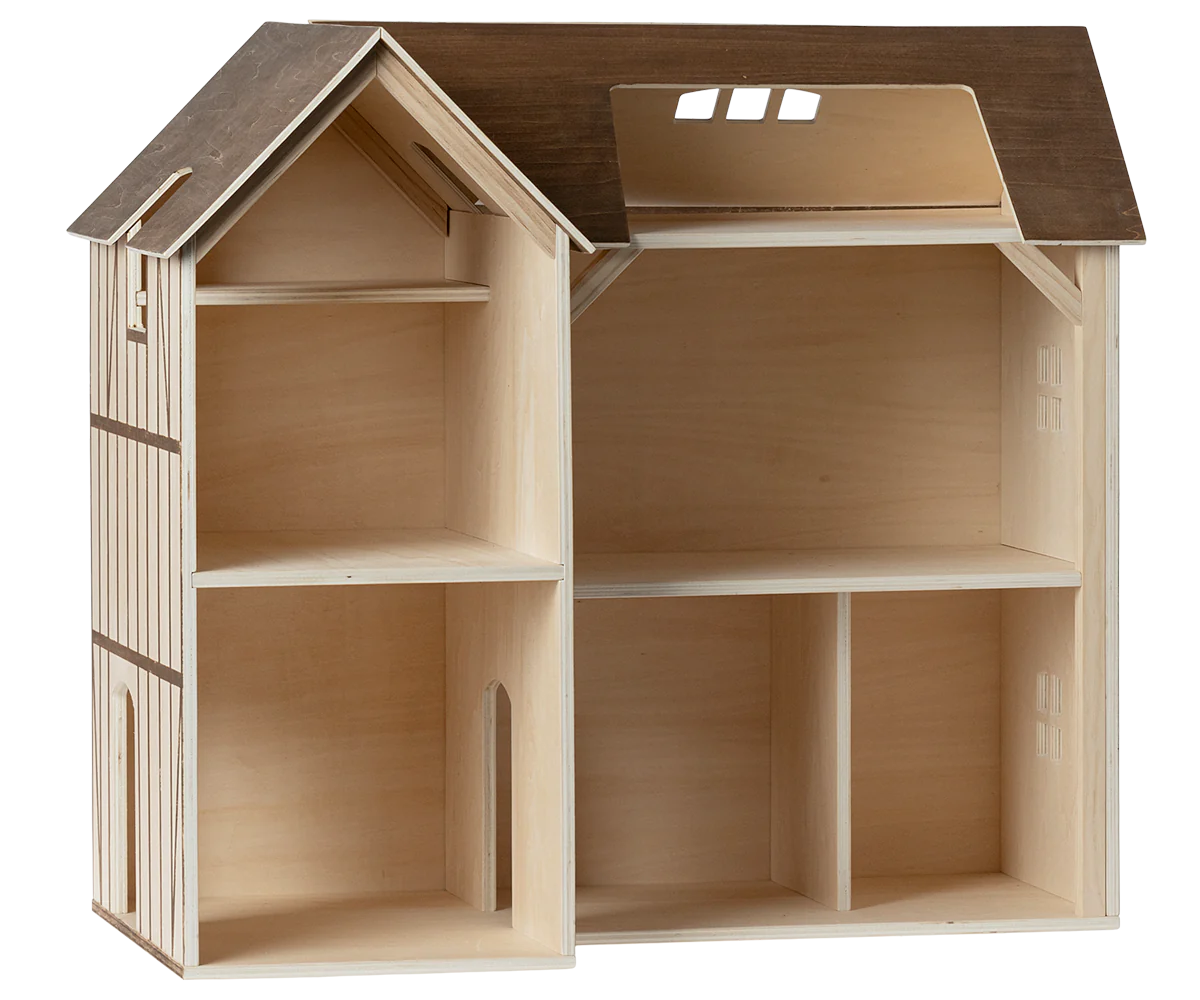 A wooden, two-story dollhouse with a peaked roof and natural wood tones is perfect for adding Maileg Furniture by Maileg or your favorite dolls to its multiple empty rooms.