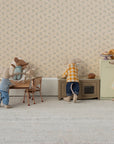 Five Maileg toy mice bring the Maileg Kitchen to life, with two at a table, one standing nearby, and two at the stove and fridge. The scene features floral wallpaper and a light carpet for added charm.