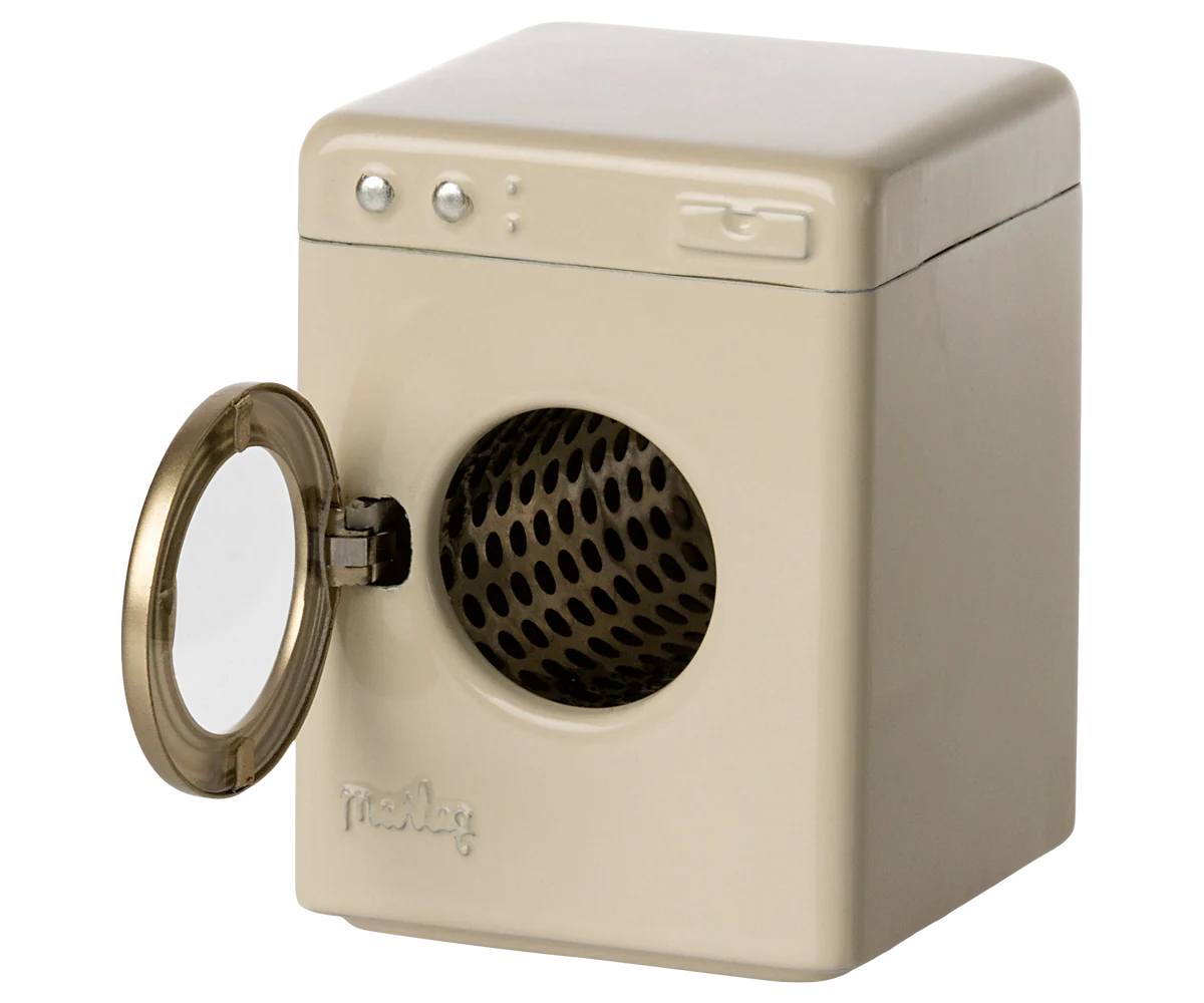 The Maileg Furniture front-loading washing machine by Maileg features a round open door and perforated metal drum. Its beige, rectangular design with simple buttons makes it an adorable dollhouse furniture addition.