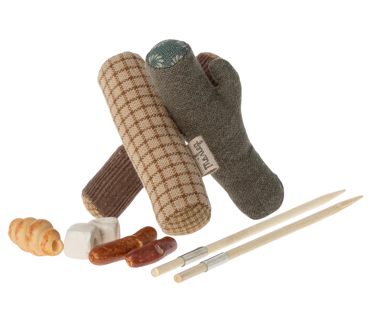 A charming Maileg Furniture set by Maileg featuring plush toy logs arranged like a campfire, small plush food items, and toy chopsticks—ideal for dollhouses or Maileg Mouse displays, all set against a white background.