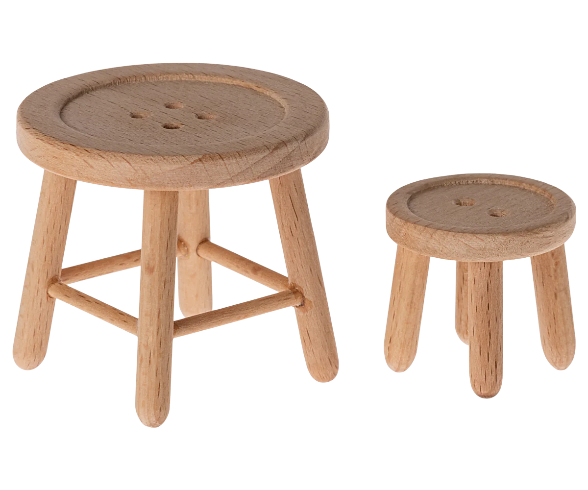The Maileg Furniture set by Maileg includes two minimalist wooden stools—one slightly larger—perfect for Maileg Mouse or dollhouse setups, each with a cute round seat design.