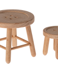 The Maileg Furniture set by Maileg includes two minimalist wooden stools—one slightly larger—perfect for Maileg Mouse or dollhouse setups, each with a cute round seat design.