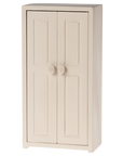 The Maileg Closet is a cream-colored, two-door wooden cabinet with simple panel detailing and round handles—ideal as dollhouse furniture or a charming miniature wardrobe—shown against a plain white background.