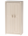 The Maileg Furniture cabinet by Maileg is a light wood piece with two doors featuring round knobs and rectangular panels—ideal for dollhouses or as cute miniature décor.