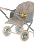 The Maileg Furniture toy stroller by Maileg features a striped fabric seat, pastel green frame, four cream wheels, and colorful beads—perfect as dollhouse furniture or for your Maileg Mouse’s imaginative play.