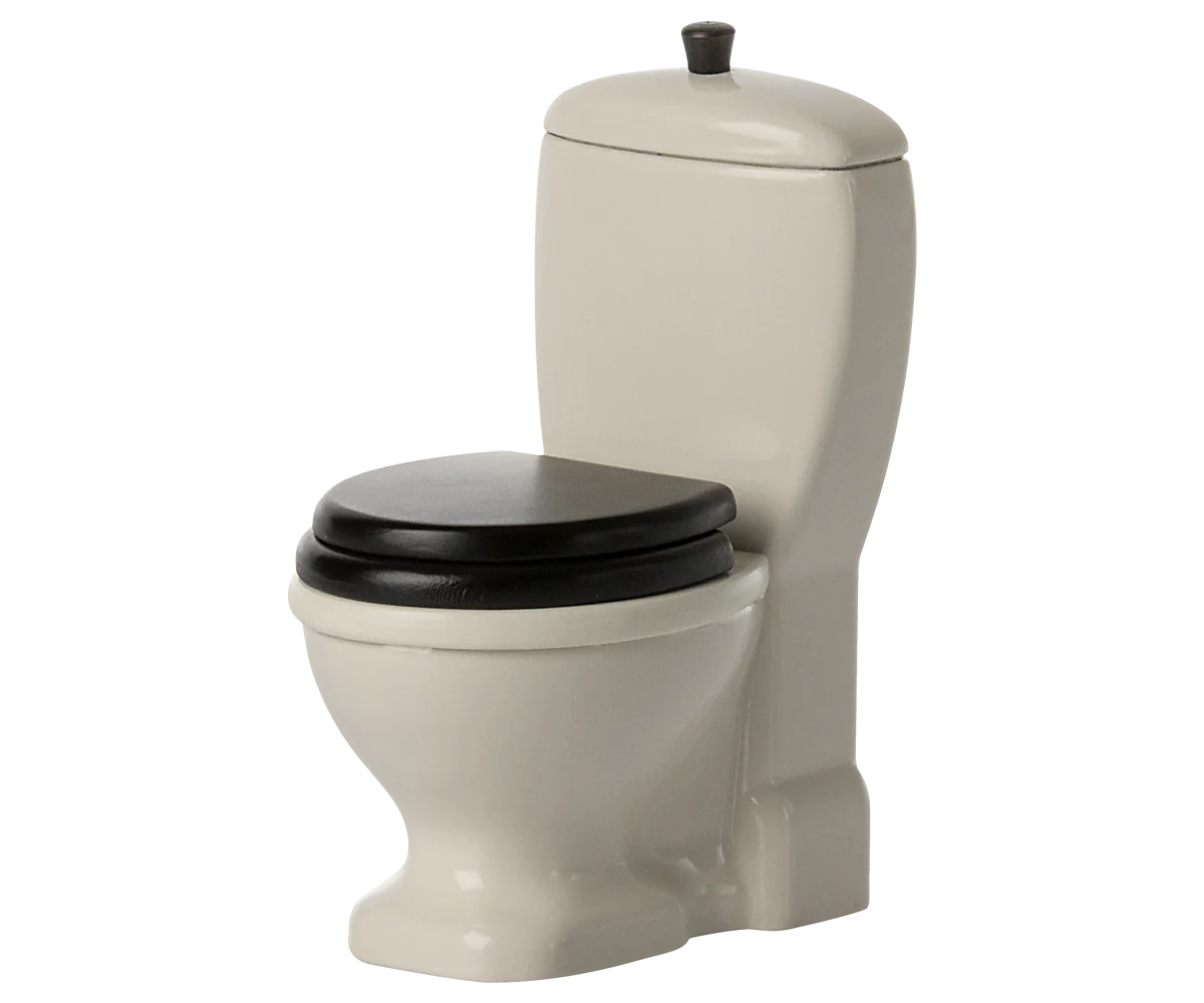 The Maileg Furniture white toilet by Maileg features a black seat and lid, standard tank, and flush handle—ideal for dollhouse displays or your Maileg Mouse collection. Presented against a plain background.