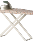 Maileg Furniture by Maileg: This small ironing board with a white frame, patterned cover, and metal iron is a charming addition for your dollhouse or Maileg Mouse setup.