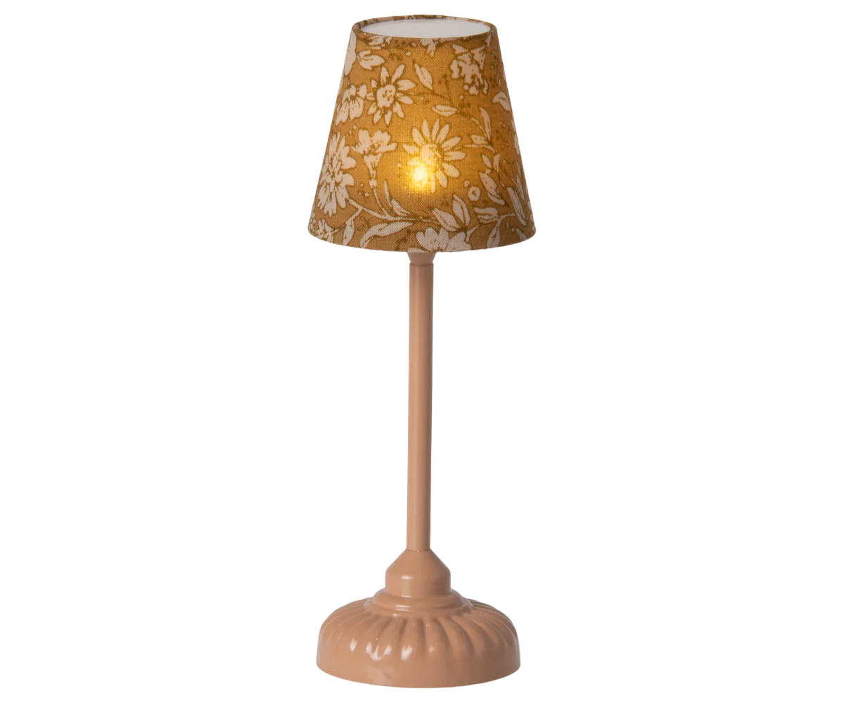 The Maileg Furniture table lamp by Maileg features a beige floral-patterned lampshade and a pink, rounded base—ideal for Maileg Mouse dollhouses and elegantly set against a neutral background.