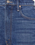 Close-up of The Half-Pipe Ankle Cuff Fray jeans by Mother, featuring a front pocket, waistband, belt loop, metal button, copper rivet, orange stitching, and textured superior denim fabric in dark blue.