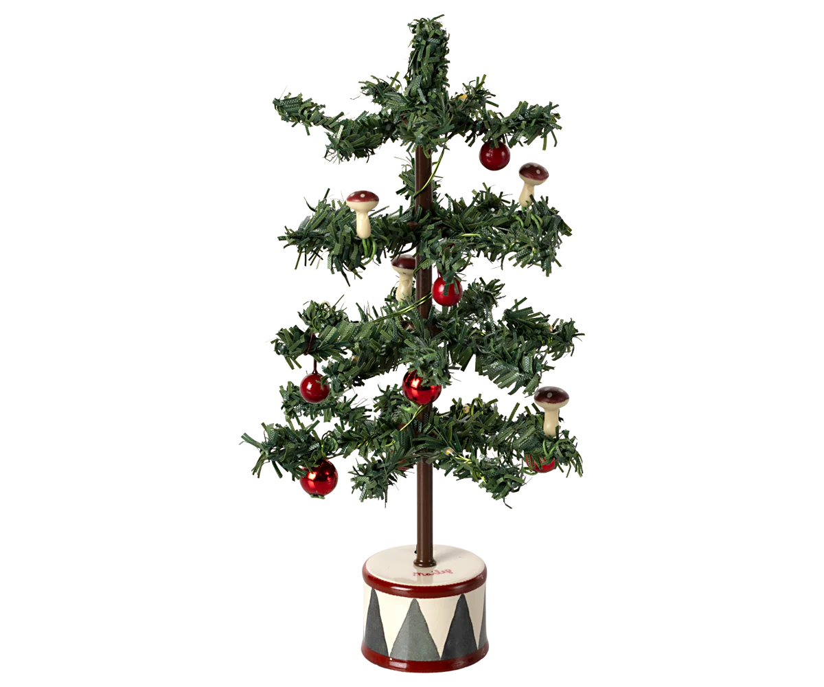 The Maileg Furniture artificial Christmas tree by Maileg features sparse green branches with red ornaments and mushrooms in a round patterned base, making it perfect for Maileg Mouse doll house decor.