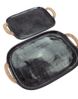The Import Collection's Chi Chi Tray Small, a black transitional-style tray with rounded edges and jute-wrapped handles, is shown with a matching large tray overlapping on a white background.