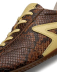 Close-up of the Rag & Bone retro runner slim ultra sneaker, featuring brown faux snakeskin texture with yellow leather accents, a bold yellow side detail, and matching yellow laces.