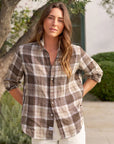 Frank & Eileen relaxed fit cotton plaid shirt in outdoor garden setting with greenery and building in the background.