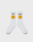 The Women's Take Out Sock WHT by Kule features two soft, white socks made in the USA—one with a smiley face and "THANK YOU," the other with "HAVE A NICE DAY." Cheerful and machine washable.