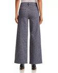FRAME Le Slim Palazzo sustainable cotton pants in black, high-rise fit, shown from the back with pointed shoes.