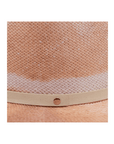 Close-up of the Cleo hat by Ninakuru, crafted from Toquilla straw. It features a textured artisanal weave in natural tones and a light beige band with a small round metal button.