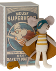 A Maileg Mouse toy from Maileg wears a striped outfit, superhero cape, and mask, standing in front of a "Mouse Superhero" matchbox with an illustration of the costumed mouse.