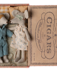 Two Maileg Mice by Maileg, dressed in pajamas and sleep masks, lie side by side in a cozy bed inside a vintage cigar box, tucked in with tiny pillows and blankets for a sweet, peaceful scene.