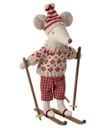 The Maileg Winter Mouse by Maileg wears a red and white sweater, plaid pants, and a pom-pom hat, standing on wooden skis with poles—ideal for fans of dressed mice and festive winter décor.