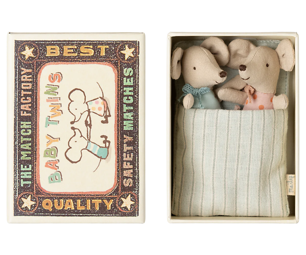 A small Maileg Mouse box from Maileg holds two mice in polka dot clothes, snuggled in a blue striped blanket. Part of the Maileg mice family; colors may vary.