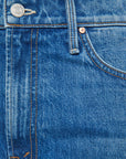 Close-up of The Dodger Ankle jeans by Mother, featuring a cotton blend in blue denim with visible orange stitching on the waistband, button, belt loop, and front pocket.