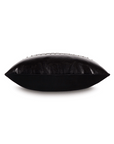 A black leather Nail Licorice Pillow, shaped like a large, flat almond, with stitched details along the edges and a Bungalow style, isolated on a white background by Eastern Accents.