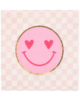The My Mind's Eye Cocktail Paper Napkin features a pink and white checkered pattern with a pink smiley face with gold-outlined heart eyes—an ideal touch for your summer barbeque.
