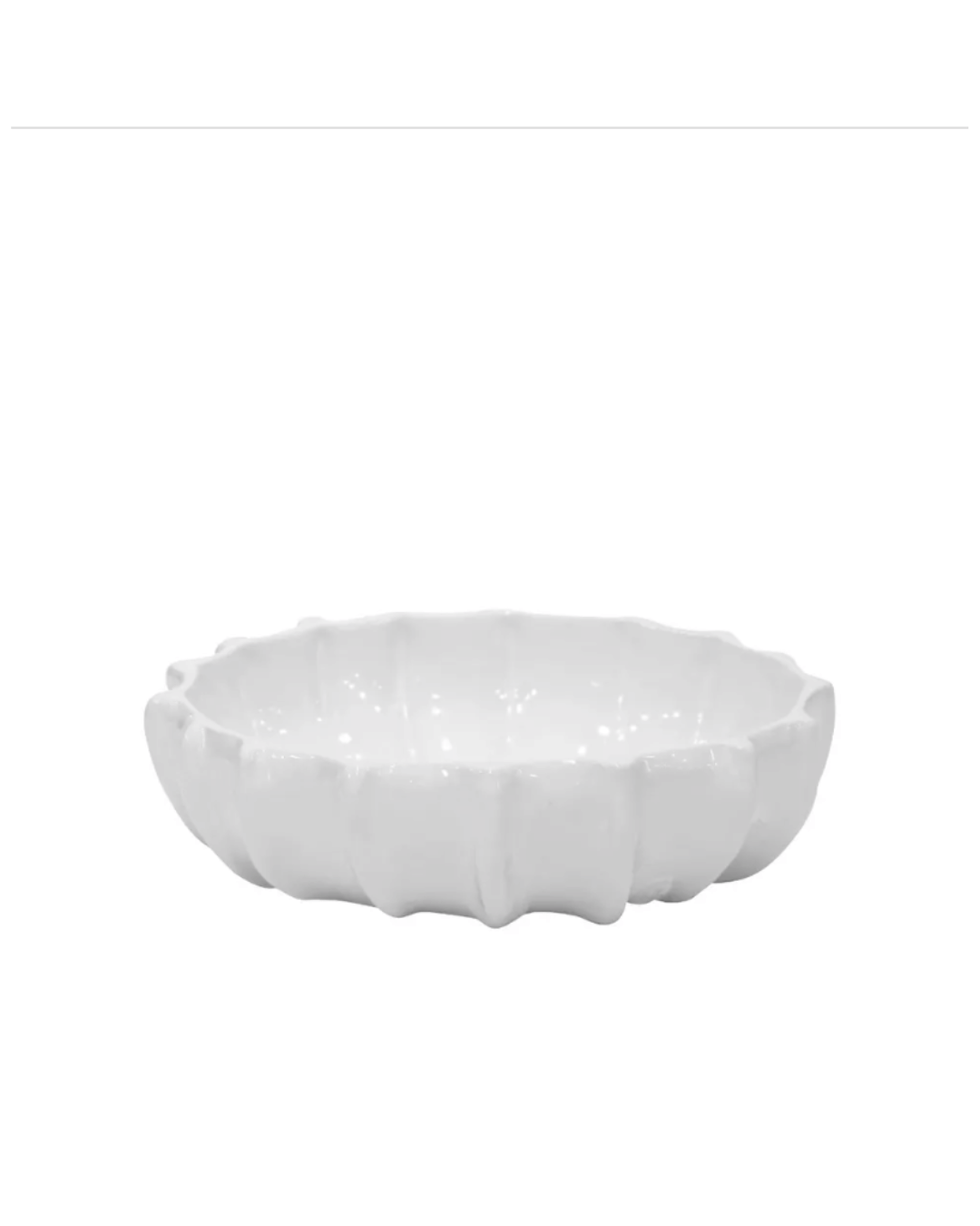 A white, ceramic Bowl No. 727 by Montes Doggett shaped like a flower with petals, set against a plain white background in a Scottsdale Arizona bungalow.