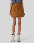 Hunter Bell NYC Dottie Skirt with a blue patterned top and silver boots, modern style against gray backdrop.