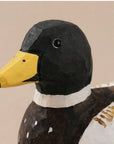 Hand-painted carved basswood duck with yellow beak and black head by Faire, rustic decor accent for home.