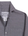 A close-up of the Frank & Eileen Oona Continuous Button-Up Shirt, featuring a black-and-white checkered pattern, collar, and continuous sleeves. The relaxed-fit shirt displays only the upper portion and left sleeve in the image.