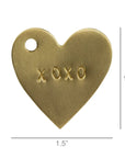 The HomArt Brass Tag XOXO is a 1.5-inch heart-shaped brass charm with "XOXO" engraved at the center and a hole near the top left, ideal as a unique gift tag for special occasions.