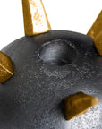 The Import Collection's Punk Candleholder features a metallic dark gray finish with gold textured spikes and a circular indentation, showcased against a white background.