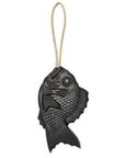 A black fish-shaped cast iron bell with detailed scales and fins and a beige rope loop evokes the look of traditional Japanese Tamanohada Soap by Faire.