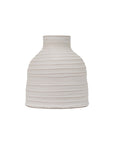 The Sheridan Narrow Vase by The Import Collection is a white, textured ceramic table vase with horizontal ridges, a wide rounded body, and a narrow short neck. It has a matte finish that enhances its simple, modern aesthetic.