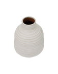 The Sheridan Narrow Vase by The Import Collection is a white ceramic vase with a ribbed texture, narrow opening, smooth rounded shape, and minimalist design. Its dark brown interior adds an unexpected touch of depth and elegance to any table setting.