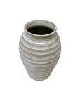 The Import Collection’s 38-429 Jaxton Short Vase displays timeless elegance with a textured, horizontal-ridged ceramic design in muted gray-beige tones—an exquisite accent for any space.