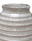 A close-up of The Import Collection's 38-429 Jaxton Short Vase highlights its timeless design with round, ribbed ceramic form and alternating textured and smooth beige, brown, and white bands. The subtly flared rim adds elegance.